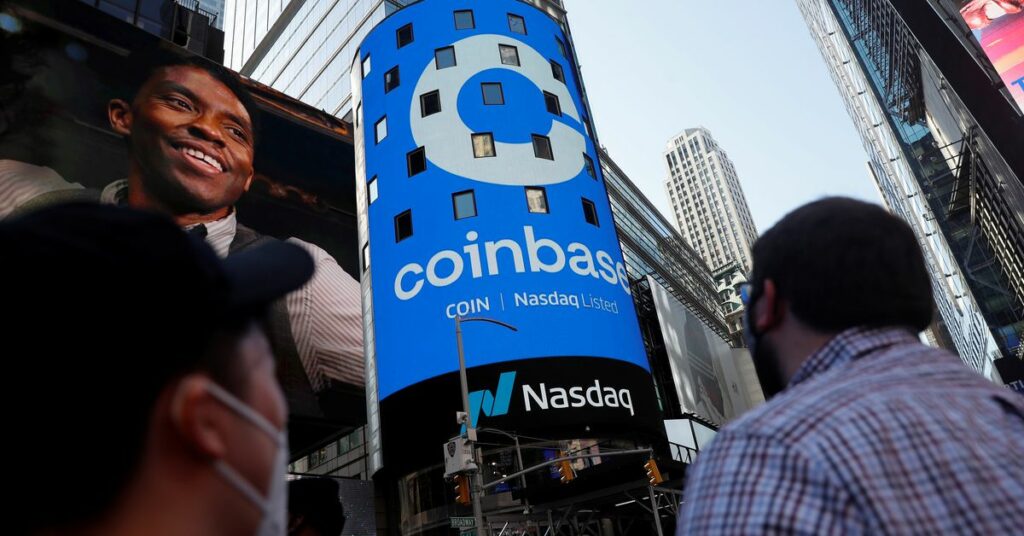 People watch as the logo for Coinbase Global Inc, the biggest U.S. cryptocurrency exchange, is displayed on the Nasdaq MarketSite jumbotron at Times Square in New York, U.S., April 14, 2021. REUTERS/Shannon Stapleton