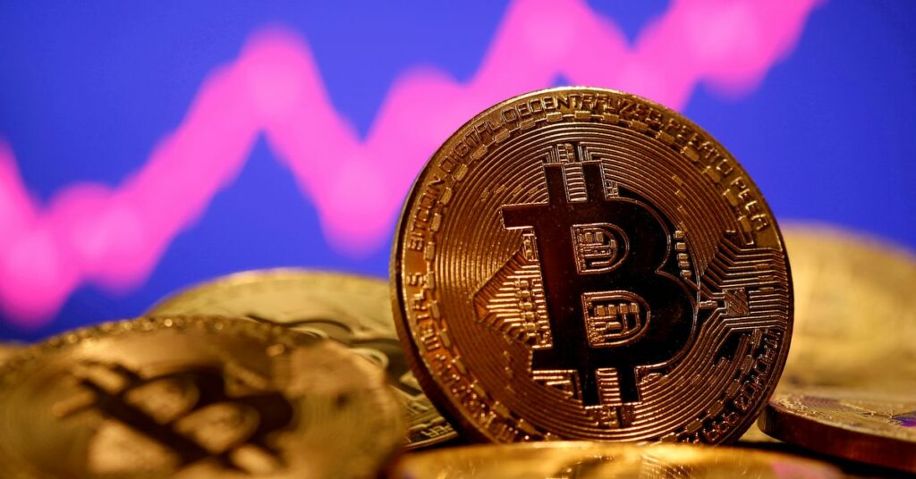 A representation of virtual currency Bitcoin is seen in front of a stock graph in this illustration taken January 8, 2021. REUTERS/Dado Ruvic/File Photo