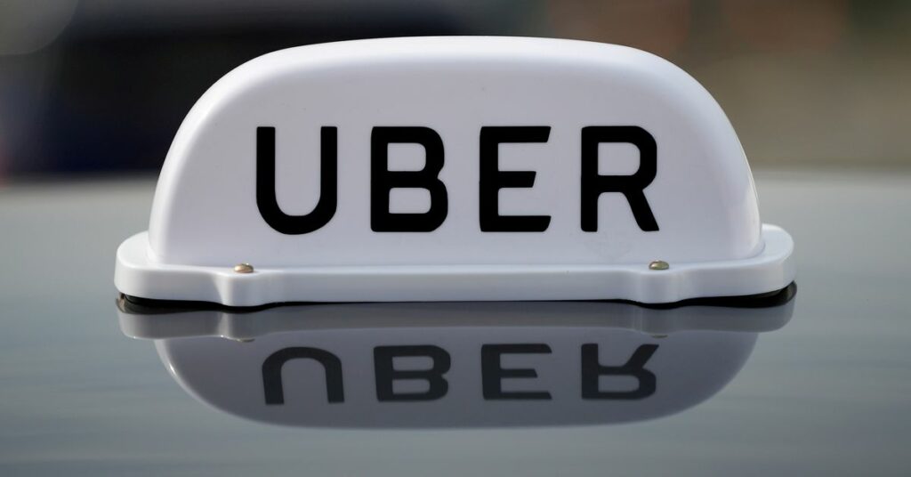 The Logo of taxi company Uber is seen on the roof of a private hire taxi in Liverpool, Britain, April 15, 2019. REUTERS/Phil Noble/File Photo