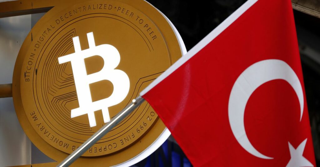 A bitcoin logo is seen next to Turkish flag at a cryptocurrency exchange shop in Istanbul, Turkey April 27, 2021. Picture taken April 27, 2021. REUTERS/Murad Sezer