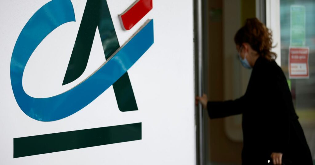 A woman walks past a Credit Agricole logo outside a bank office in Reze near Nantes, France, May 12, 2021. REUTERS/Stephane Mahe