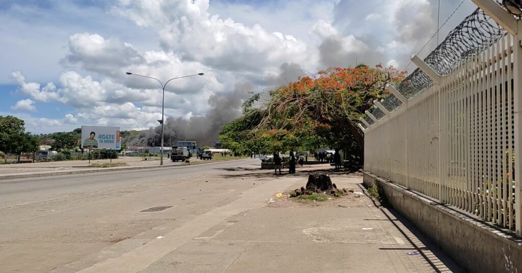 Smoke is seen after buildings were set on fire in Chinatown, as Solomon Islanders defied a government-imposed lockdown and protested in the capital, in Honiara, Solomon Islands November 25, 2021, in this still image taken from video provided on social media. Mandatory credit Georgina Kekea/via REUTERS