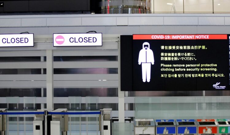 A notice about COVID-19 safety measures is pictured next to closed doors at a departure hall of Narita international airport on the first day of closed borders to prevent the spread of the new coronavirus Omicron variant in Narita, east of Tokyo, Japan, November 30, 2021. REUTERS/Kim Kyung-Hoon