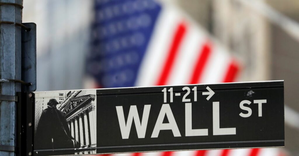 A street sign for Wall Street is seen outside the New York Stock Exchange (NYSE) in New York City, New York, U.S., July 19, 2021. REUTERS/Andrew Kelly