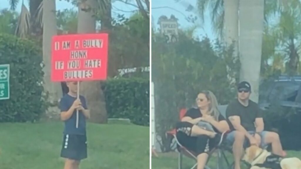 Los padres provocan un debate mientras un niño sostiene un cartel de matón al costado de la carretera