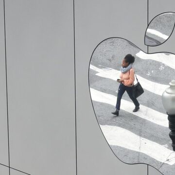 A woman is reflected in a Apple store logo in San Francisco, California, U.S., August 21, 2017. REUTERS/Kevin Coombs