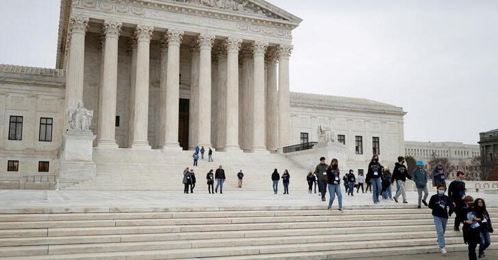 A visiting school group walks along the plaza at the U.S. Supreme Court on Capitol Hill in Washington, U.S., February 22, 2022. REUTERS/Tom Brenner/File Photo