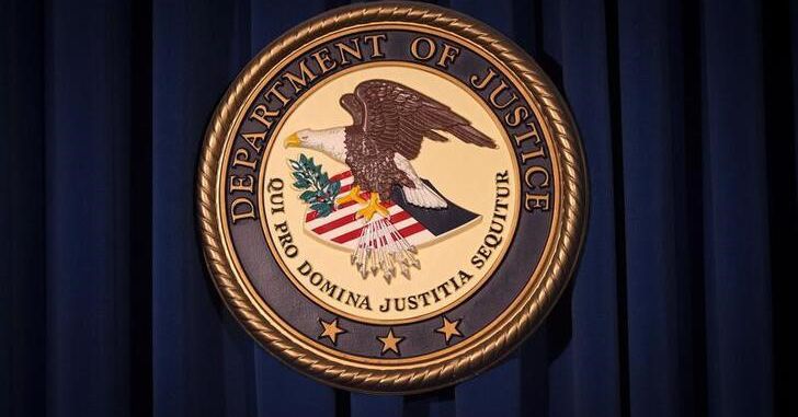 The Department of Justice (DOJ) logo is pictured on a wall in New York December 5, 2013. REUTERS/Carlo Allegri