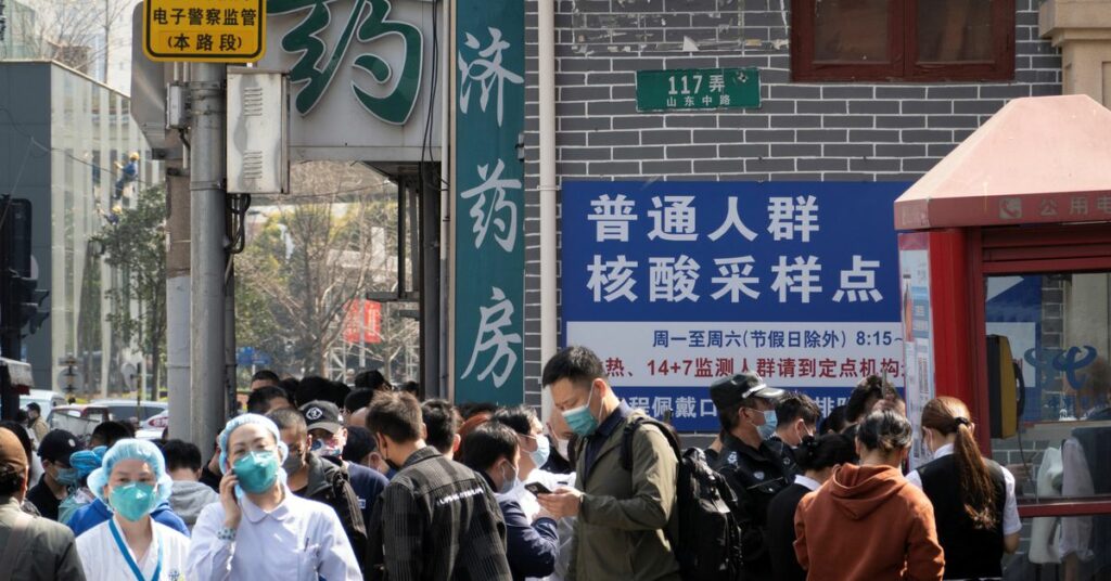 Residents line up outside a nucleic acid testing site of a hospital in Shanghai