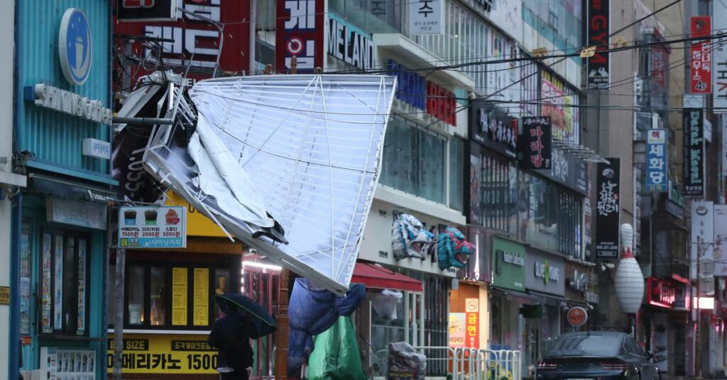 A wave caused by Typhoon Hinnamnor hits the waterfront in Busan,