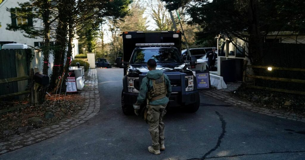 Secret Service personnel park vehicles in the driveway leading to U.S. President Joe Biden