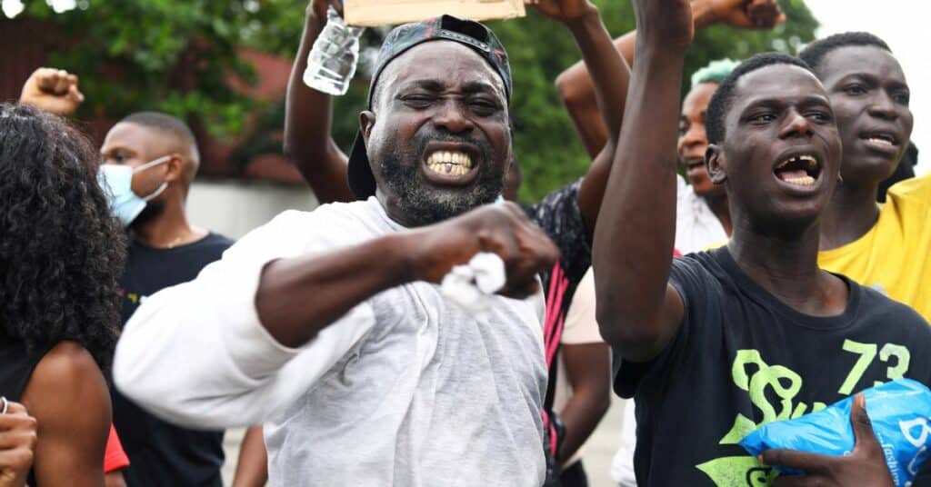 Nigerians take part in a protest against alleged violence, extortion and harrassment from Nigeria