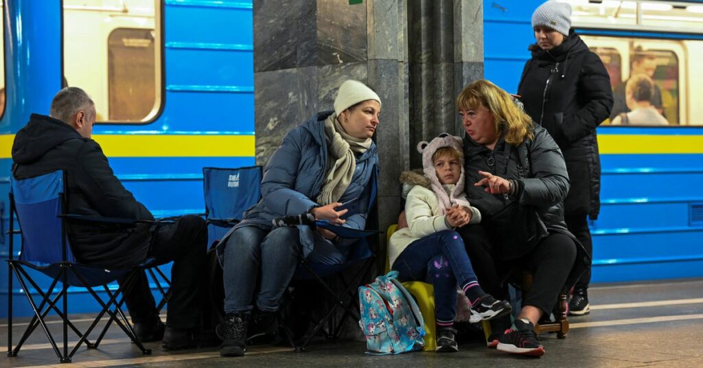 People take shelter inside a metro station during massive Russian missile attacks in Kyiv