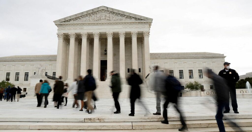 People walk across the plaza to enter the U.S. Supreme Court building on the first day of the court’s new term in Washington
