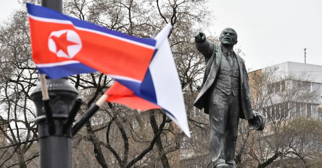 State flags of Russia and North Korea fly in a street in Vladivostok