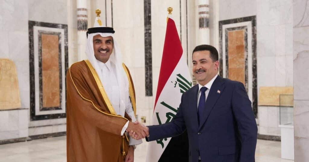 Iraqi PM Mohammed Shia al-Sudani shakes hands with Qatar's Emir Sheikh Tamim bin Hamad al-Thani during a welcome ceremony, in Baghdad