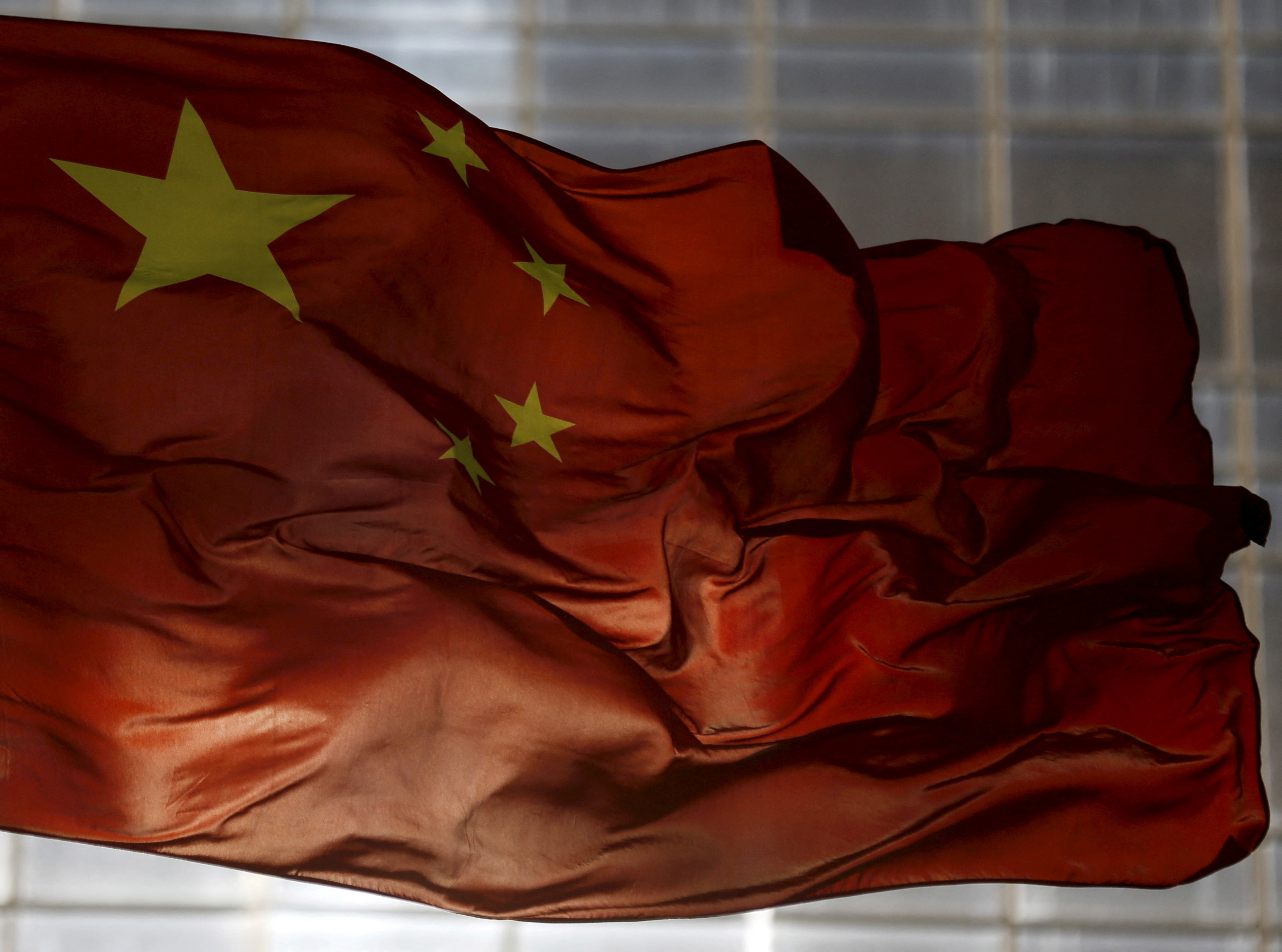 La bandera nacional de China ondea en un distrito comercial de Beijing